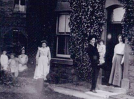 The Evans family at their home in England. Rice and Louise are standing at the door, holding Bergen. The older children are at far left. The girl in white is, I suppose, a maid.